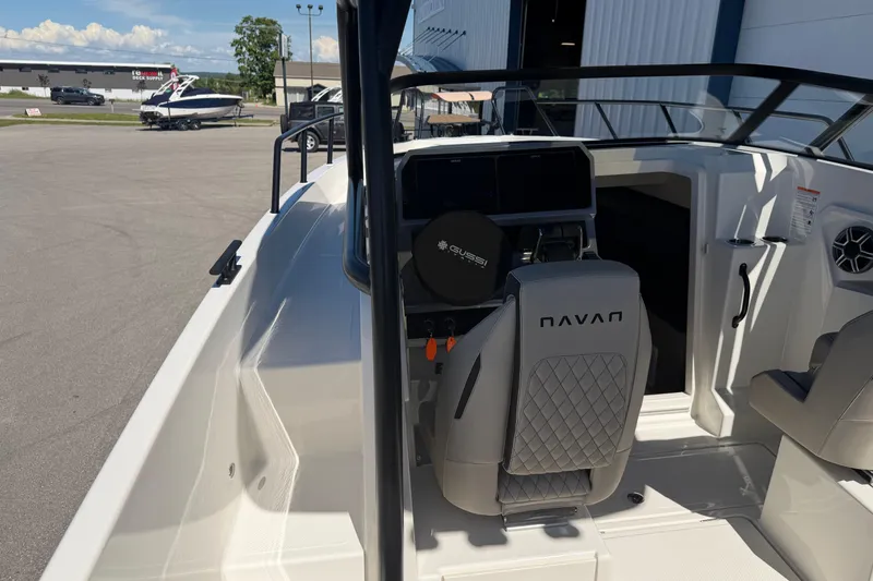 Slide: The Image of 2026 Navan S30 boat interior with modern helm and seating, docked outdoors. - 21