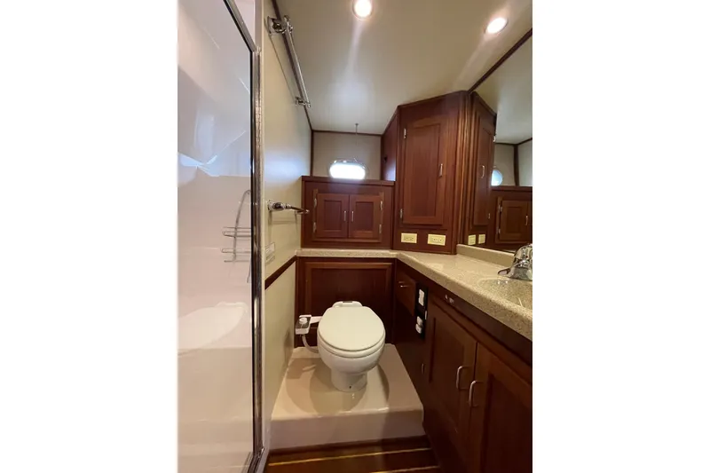 Slide: The Image of Luxurious bathroom in 2006 American Tug 41 yacht with wooden cabinetry and modern fixtures. - 17
