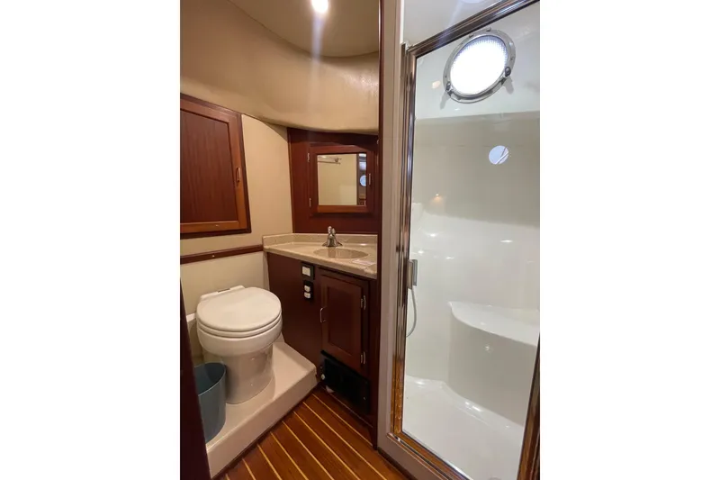 Slide: The Image of Luxurious bathroom in 2006 American Tug 41 yacht with wood accents and modern fixtures. - 31