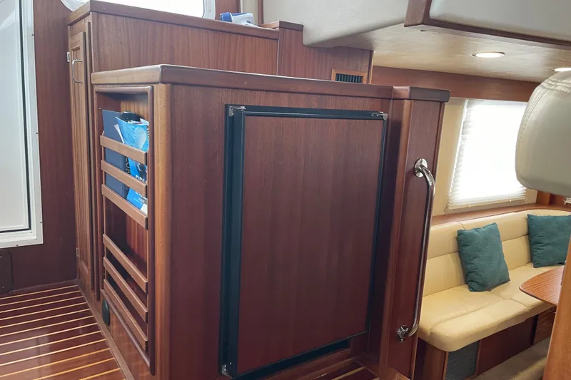 Slide: The Image of Interior of 2006 American Tug 41 with wood cabinetry and cozy seating area. - 7