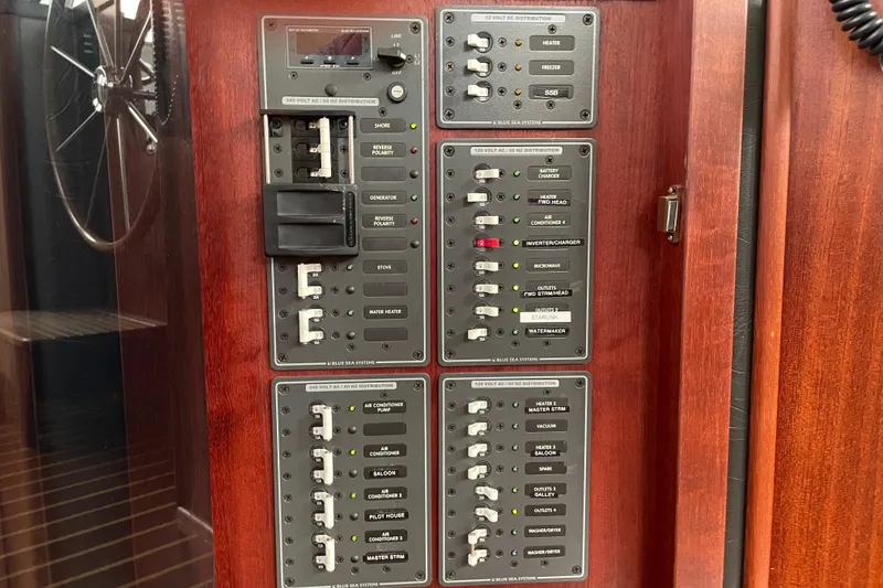 Slide: The Image of Electrical panel on a 2006 American Tug 41 boat, featuring various switches and controls. - 21