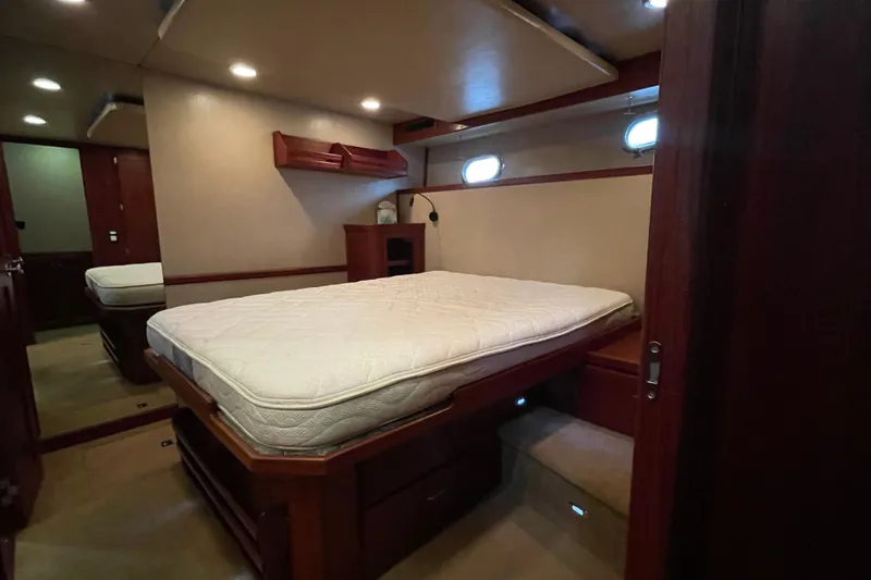 Slide: The Image of Luxurious cabin interior of a 2006 American Tug 41 with a comfortable bed and wooden accents. - 8