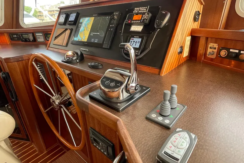 Slide: The Image of Helm of 2006 American Tug 41 with navigation controls and wooden steering wheel. - 15