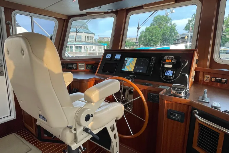 Slide: The Image of Pilot house of a 2006 American Tug 41 with navigation equipment and captain's chair. - 4