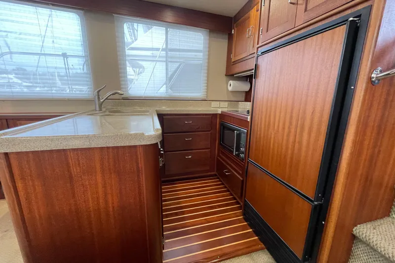 Slide: The Image of 2006 American Tug 41 yacht kitchen with wood cabinetry and modern appliances. - 9