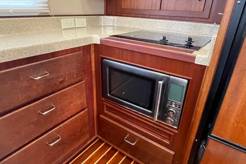 Slide: The Image of Kitchen area of 2006 American Tug 41 with microwave and stove. - 12