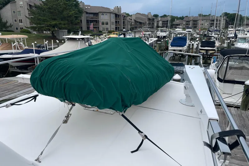 Slide: The Image of 2006 American Tug 41 yacht with green cover at marina dock. - 23