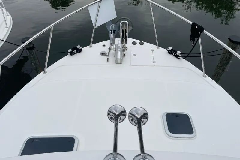 Slide: The Image of Bow view of 2006 American Tug 41, featuring deck and railing details. - 28