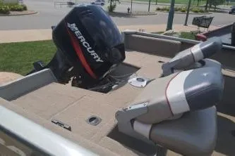 Slide: The Image of 2006 Tracker Pro Guide V-16 SC boat with Mercury outboard motor, parked outdoors. - 5