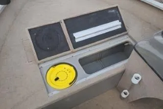 Slide: The Image of 2006 Tracker Pro Guide V-16 SC boat dashboard with storage compartments and speaker. - 12