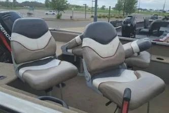 Slide: The Image of 2006 Tracker Pro Guide V-16 SC boat seats in a parking lot setting. - 6