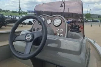 Slide: The Image of 2006 Tracker Pro Guide V-16 SC boat dashboard with steering wheel and gauges. - 8