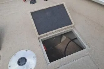 Slide: The Image of 2006 Tracker Pro Guide V-16 SC boat storage compartment with open hatch. - 13