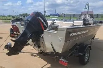 Slide: The Image of 2006 Tracker Pro Guide V-16 SC boat with Mercury outboard motor on trailer. - 4