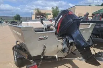 Slide: The Image of 2006 Tracker Pro Guide V-16 SC boat with motor on trailer, outdoors. - 3