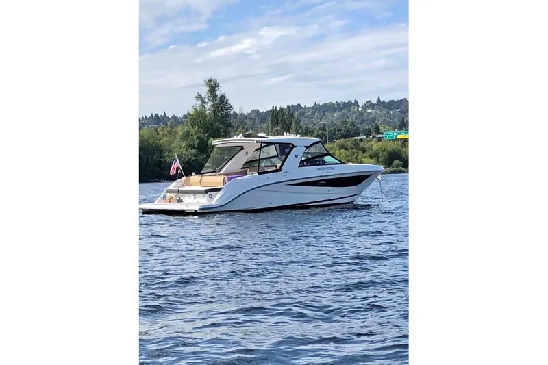 Slide: The Image of 2018 Sea Ray SLX 400 boat on a scenic lake with lush greenery. - 11