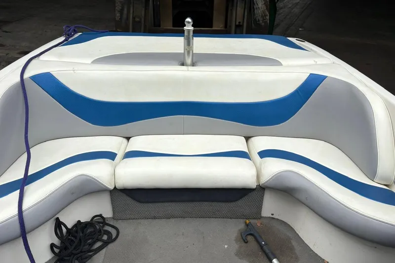 Slide: The Image of 1999 MasterCraft MariStar 230 Sport boat interior with blue and white seating. - 11