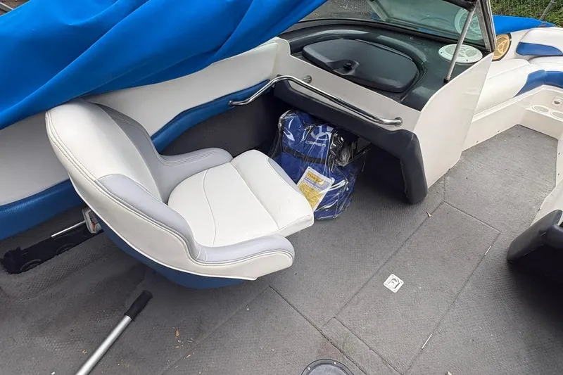 Slide: The Image of Interior of a 1999 MasterCraft MariStar 230 Sport boat with white and blue seating. - 5