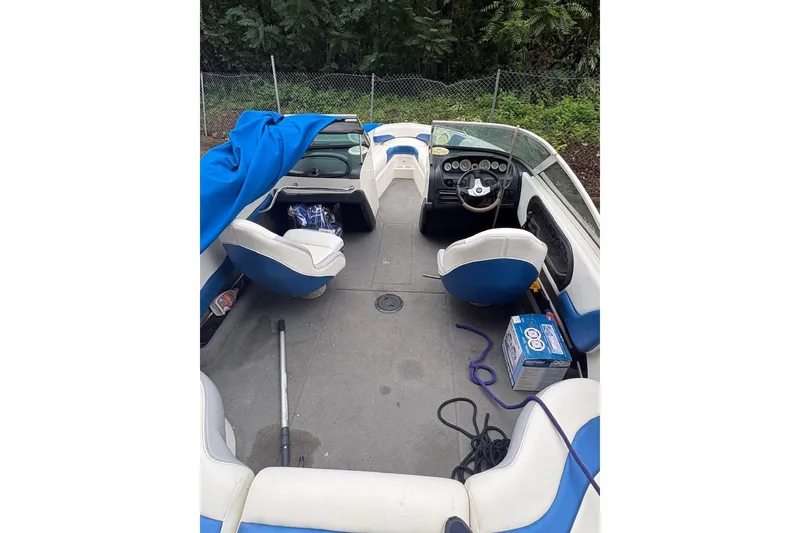 Slide: The Image of 1999 MasterCraft MariStar 230 Sport boat interior with blue and white seating. - 4