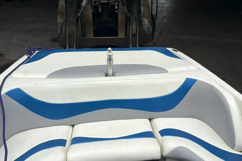 Slide: The Image of 1999 MasterCraft MariStar 230 Sport boat interior with blue and white seating. - 10