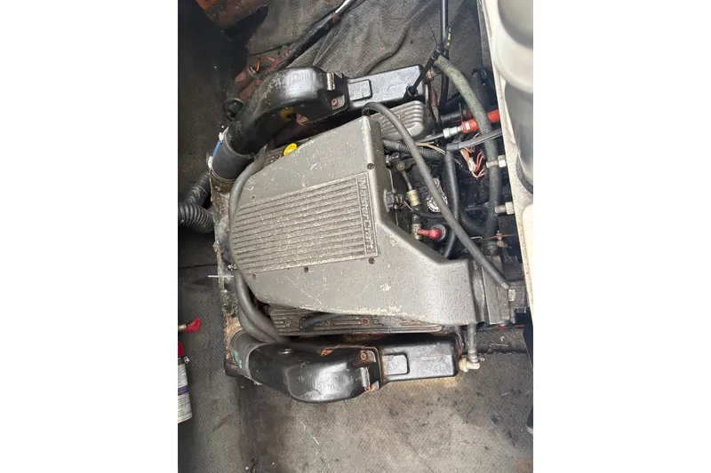 Slide: The Image of 1999 MasterCraft MariStar 230 Sport engine compartment, showcasing detailed mechanical components. - 12