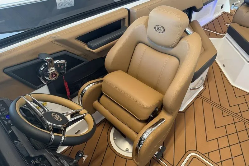 Slide: The Image of Luxurious interior of 2026 Cobalt R4 boat with tan leather seating and modern steering wheel. - 10