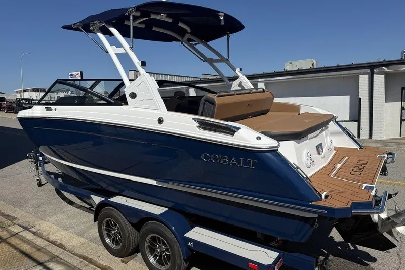 Slide: The Image of 2026 Cobalt R4 boat with blue hull and tan interior on a trailer. - 3