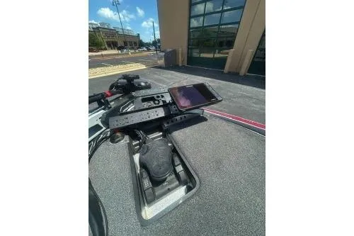 Slide: The Image of 2022 Triton 19 TrX Patriot dashboard with mounted smartphone in outdoor setting. - 9