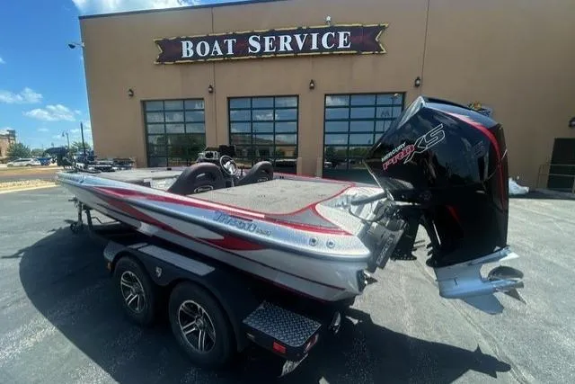 Slide: The Image of 2022 Triton 19 TrX Patriot boat parked outside a boat service center. - 4