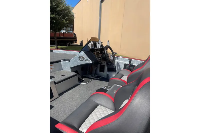 Slide: The Image of 2022 Triton 19 TrX Patriot boat interior with steering console and dual seats. - 9