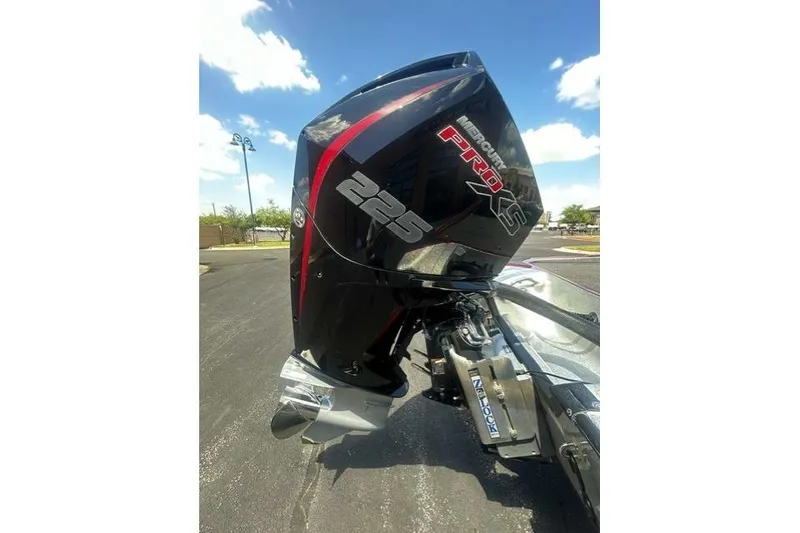 Slide: The Image of Mercury Pro XS 225 engine on 2022 Triton 19 TrX Patriot boat under clear sky. - 6
