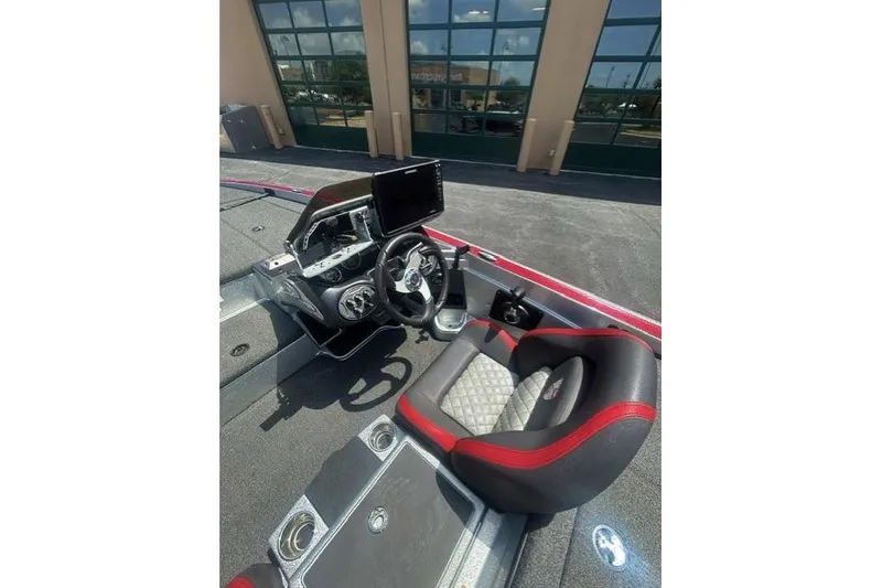 Slide: The Image of 2022 Triton 19 TrX Patriot boat interior with steering wheel and seating. - 10