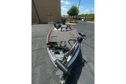 Slide: The Image of 2022 Triton 19 TrX Patriot boat, parked outdoors, showcasing deck and equipment. - 5