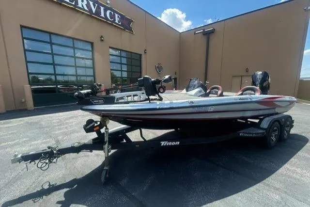 Slide: The Image of 2022 Triton 19 TrX Patriot boat on trailer outside service center. - 3