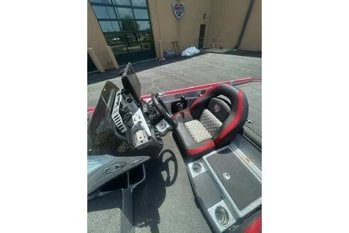 Slide: The Image of 2022 Triton 19 TrX Patriot boat interior with steering wheel and seating. - 8