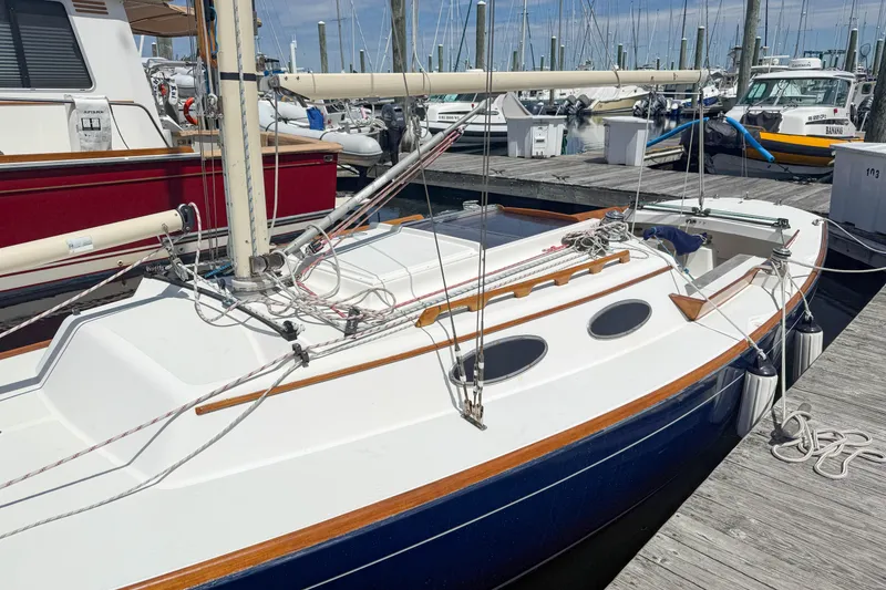 Slide: The Image of 1997 Alerion Express 28 sailboat docked at a marina, showcasing sleek design and craftsmanship. - 4