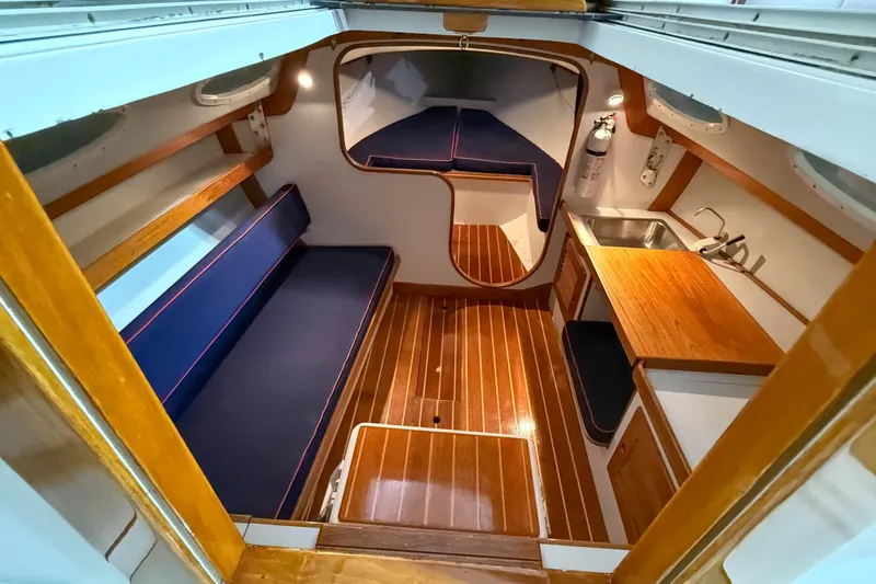 Slide: The Image of Interior of 1997 Alerion Express 28 sailboat with wood flooring and compact kitchenette. - 16