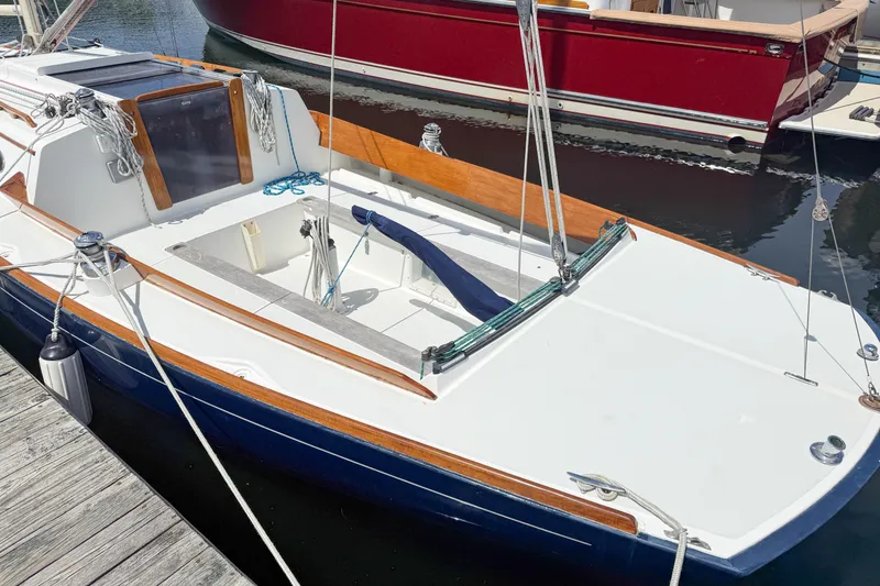 Slide: The Image of 1997 Alerion Express 28 sailboat docked, featuring sleek design and wooden accents. - 3