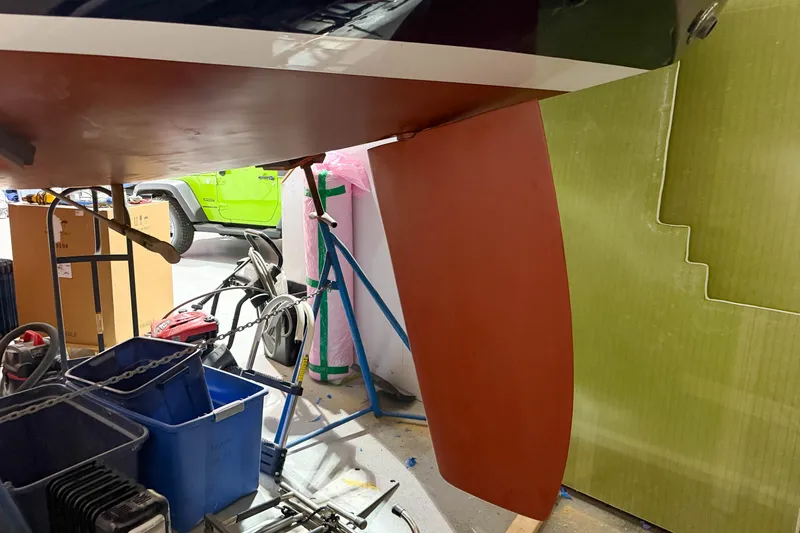 Slide: The Image of 1997 Alerion Express 28 sailboat keel in a workshop setting. - 27
