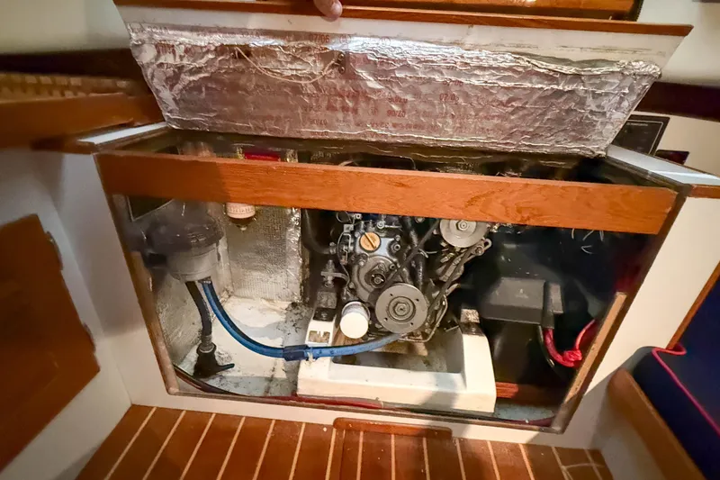 Slide: The Image of Engine compartment of a 1997 Alerion Express 28 sailboat, showcasing mechanical components. - 24