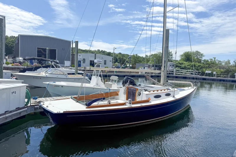 The Image of 1997 Alerion Express 28 sailboat docked at a marina under a clear blue sky. - 1
