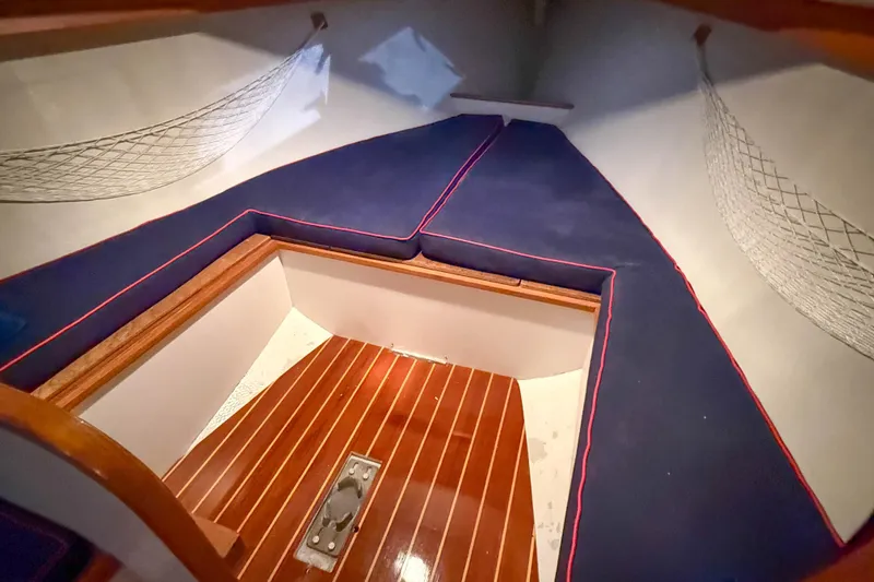 Slide: The Image of Interior cabin of a 1997 Alerion Express 28 sailboat with blue cushions and wooden flooring. - 20