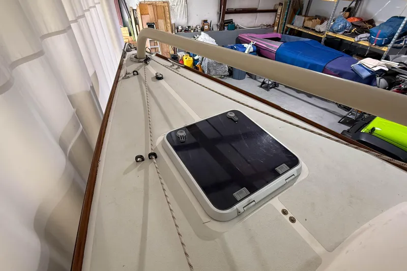 Slide: The Image of 1997 Alerion Express 28 sailboat deck with hatch in storage facility. - 8