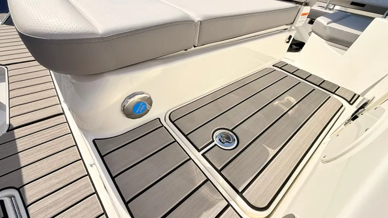 Slide: The Image of The image shows the deck of a 2026 Sea Ray SDX 250 Outboard with sleek wooden flooring. - 16