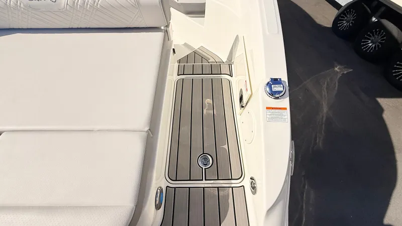 Slide: The Image of The image shows the deck of a Sea Ray SDX 250 Outboard boat with sleek wood accents. - 15
