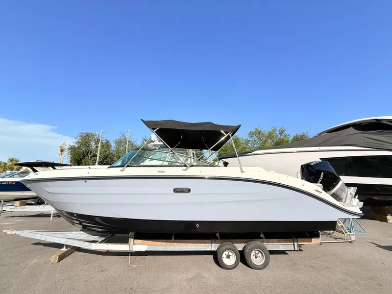 Slide: The Image of A 2026 Sea Ray SDX 250 Outboard sits on a trailer. It features a black canopy. - 0