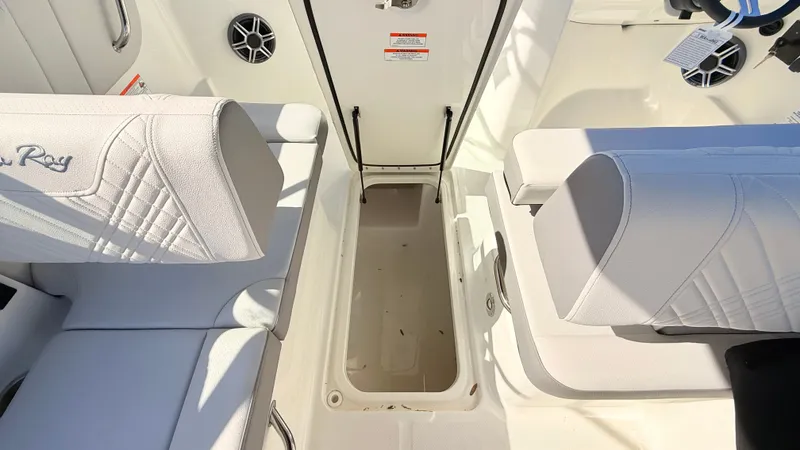 Slide: The Image of Interior view of a Sea Ray SDX 250 Outboard with white upholstery and storage compartment. - 44