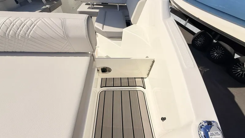 Slide: The Image of The image shows the deck of a 2026 Sea Ray SDX 250 Outboard with sleek upholstery and wood flooring. - 18