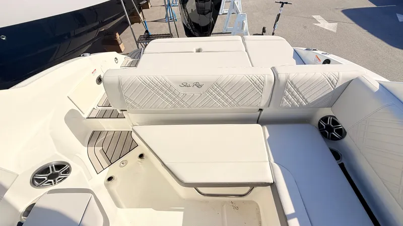 Slide: The Image of The image shows the luxurious cockpit of a Sea Ray SDX 250 Outboard with elegant white upholstery. - 19