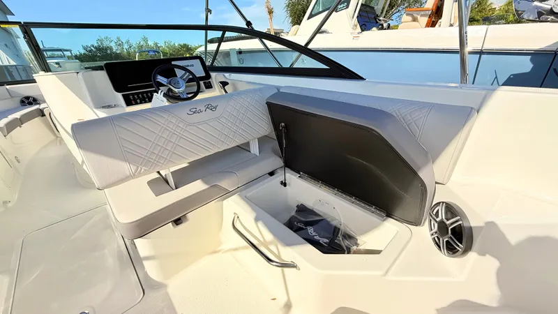 Slide: The Image of The image shows the cockpit of a 2026 Sea Ray SDX 250 Outboard with sleek seating and a modern helm. - 26